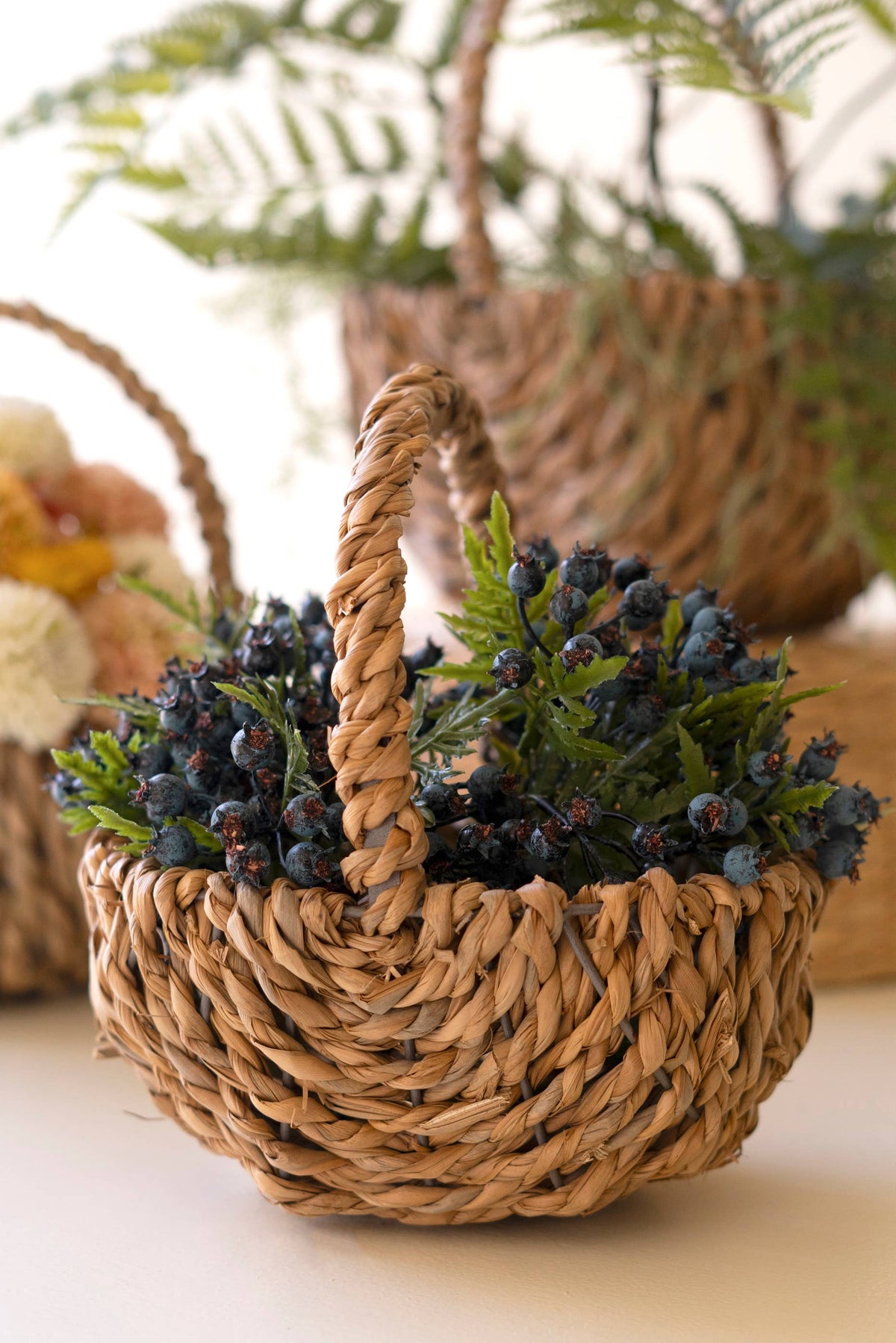 SET OF THREE WOVEN SEAGRASS BASKETS WITH HANDLES