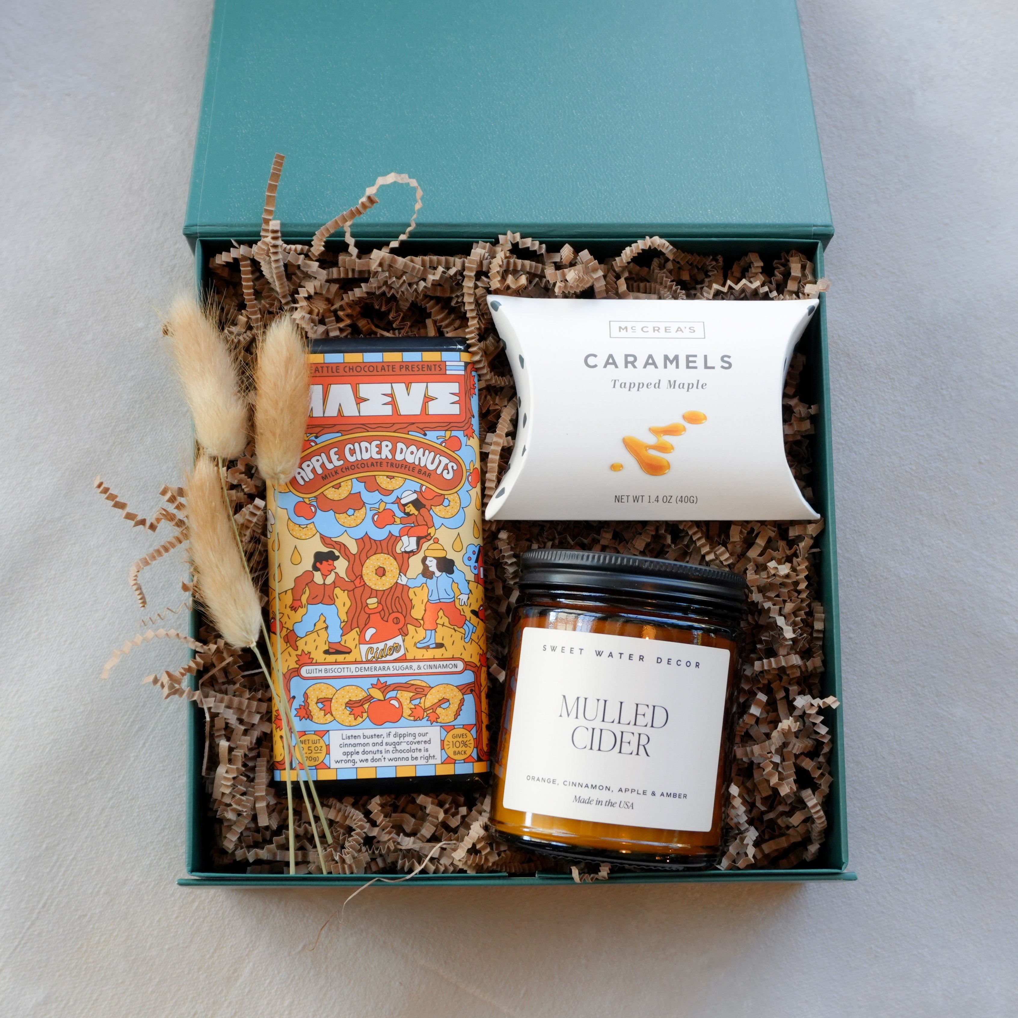 Curated autumn gift box with apple cider donut chocolate bar, caramels, and mulled cider candle. By Kraft & Co Floral and Gift
